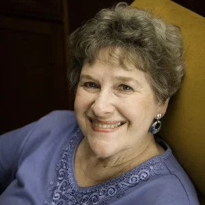 Headshot of older woman with short curly hair