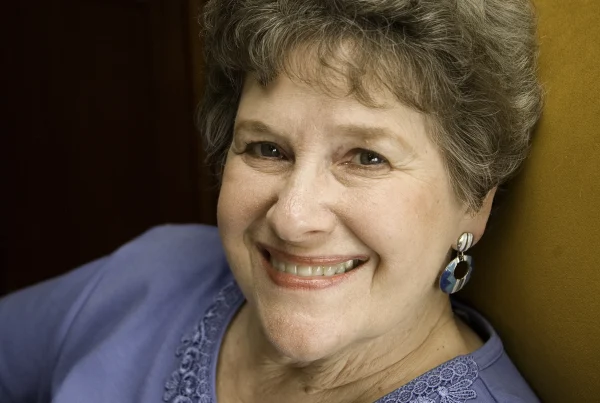 Headshot of older woman with short curly hair